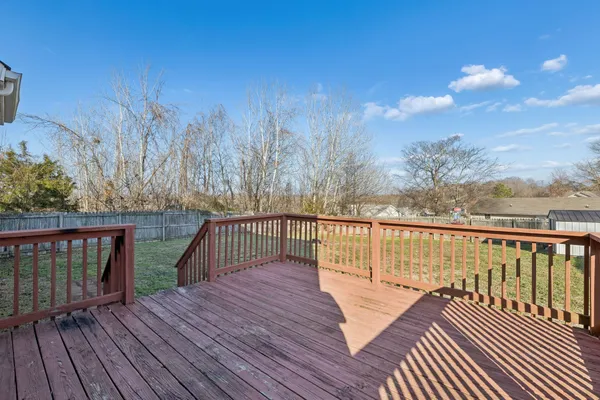a balcony with wooden floor and fence