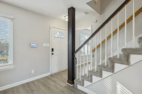 a view of entryway with wooden floor and stairs
