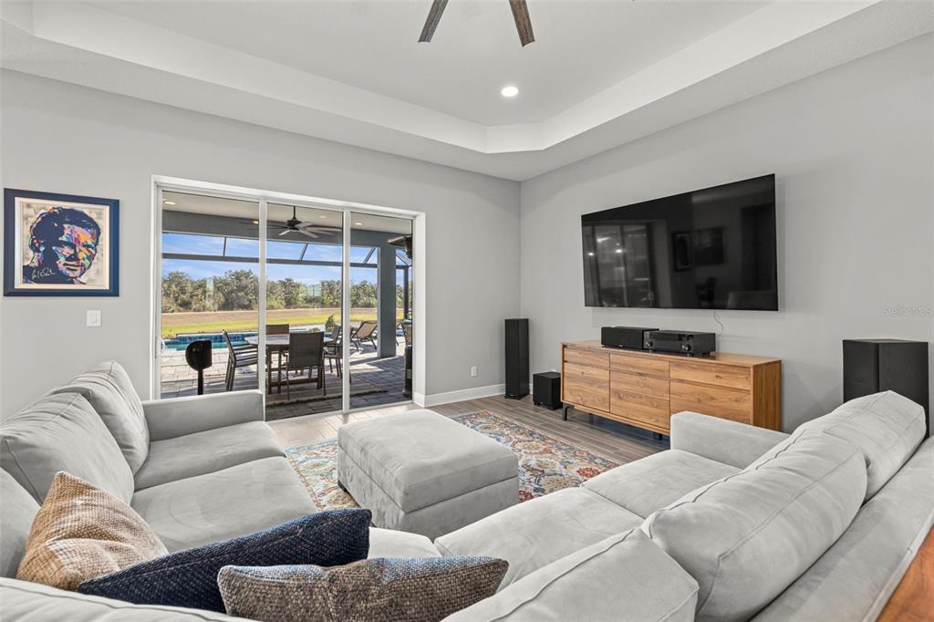 14375 Skipping Stone Loop Parrish, FL 34219 - Photo 14 of 87 a living room with furniture and a flat screen tv