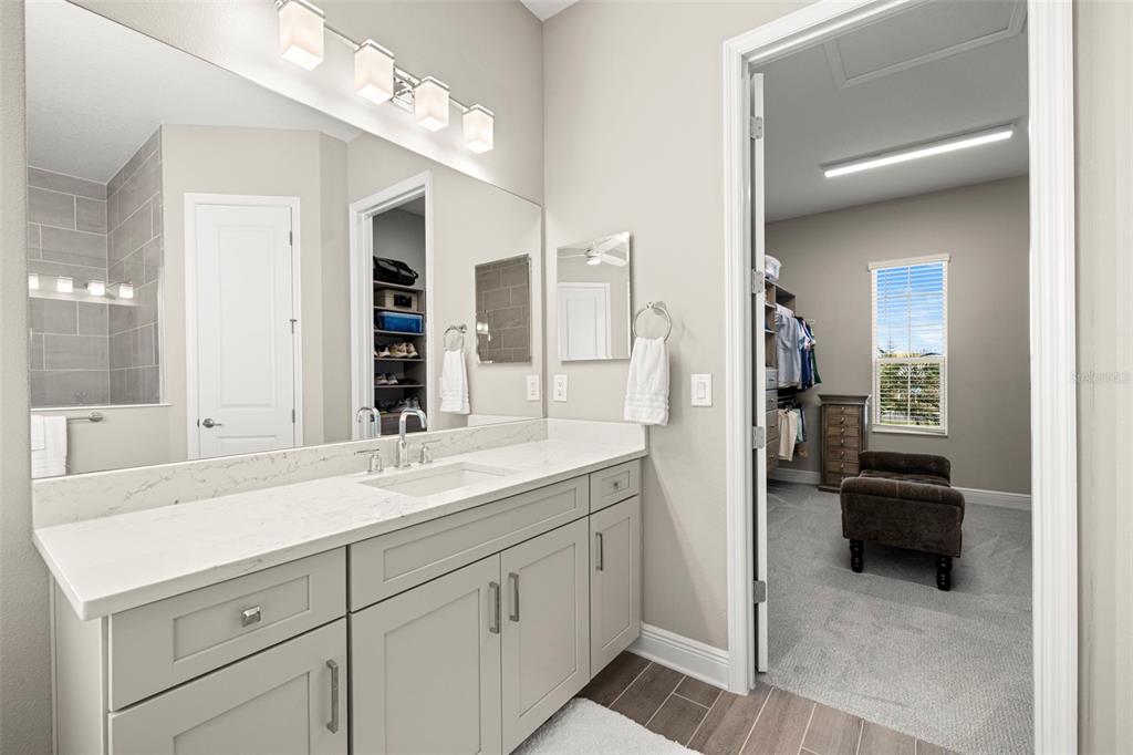 14375 Skipping Stone Loop Parrish, FL 34219 - Photo 29 of 87 a en suite bathroom with double sink and a mirror
