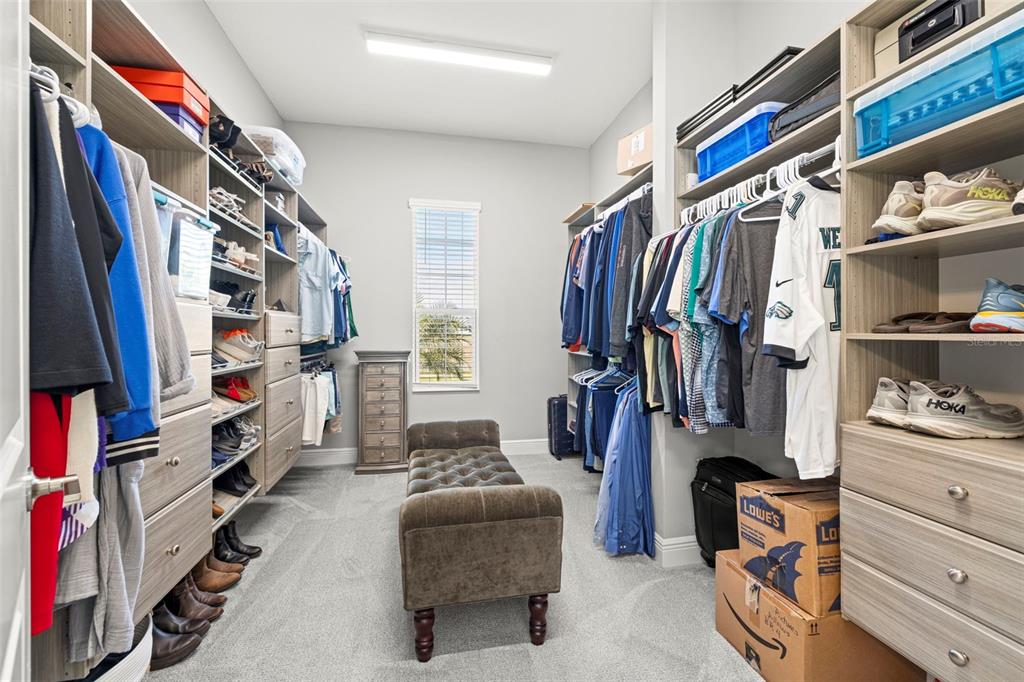 14375 Skipping Stone Loop Parrish, FL 34219 - Photo 31 of 87 a view of walk in closet with clothes and shoes