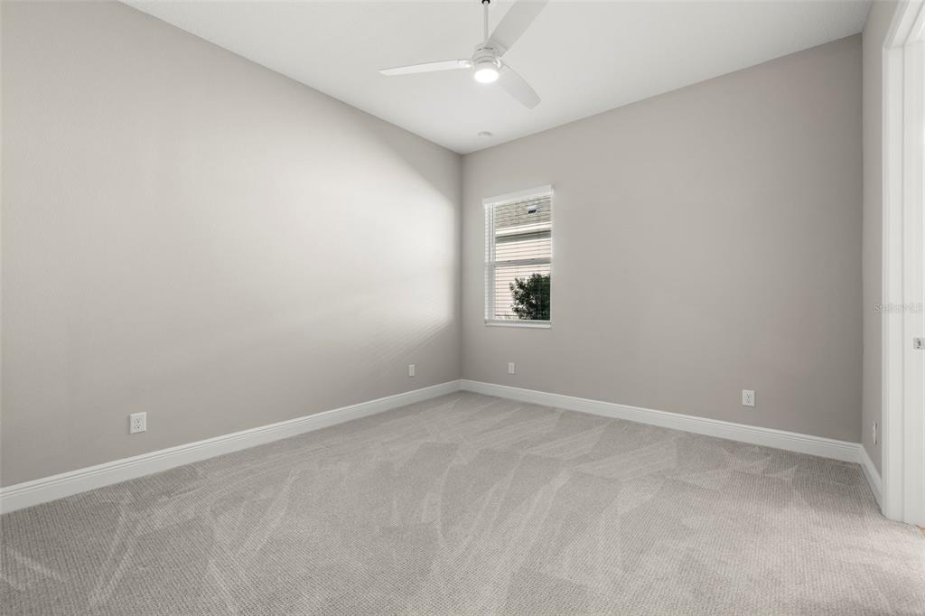 14375 Skipping Stone Loop Parrish, FL 34219 - Photo 35 of 87 an empty room with windows and chandelier fan