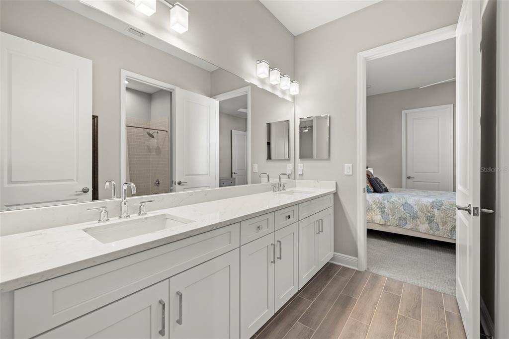 14375 Skipping Stone Loop Parrish, FL 34219 - Photo 37 of 87 a en suite bathroom with double vanity and a mirror
