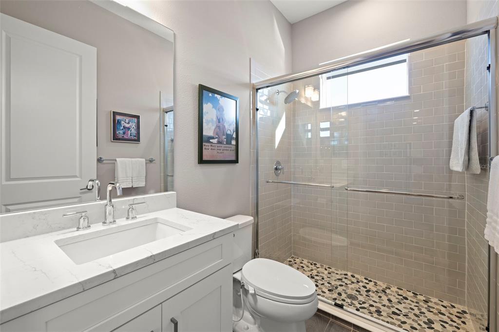 14375 Skipping Stone Loop Parrish, FL 34219 - Photo 41 of 87 a bathroom with a sink toilet a mirror and shower