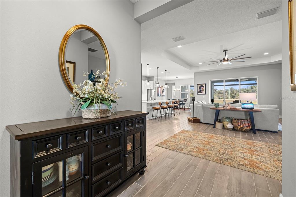 14375 Skipping Stone Loop Parrish, FL 34219 - Photo 6 of 87 a living room with furniture and a mirror