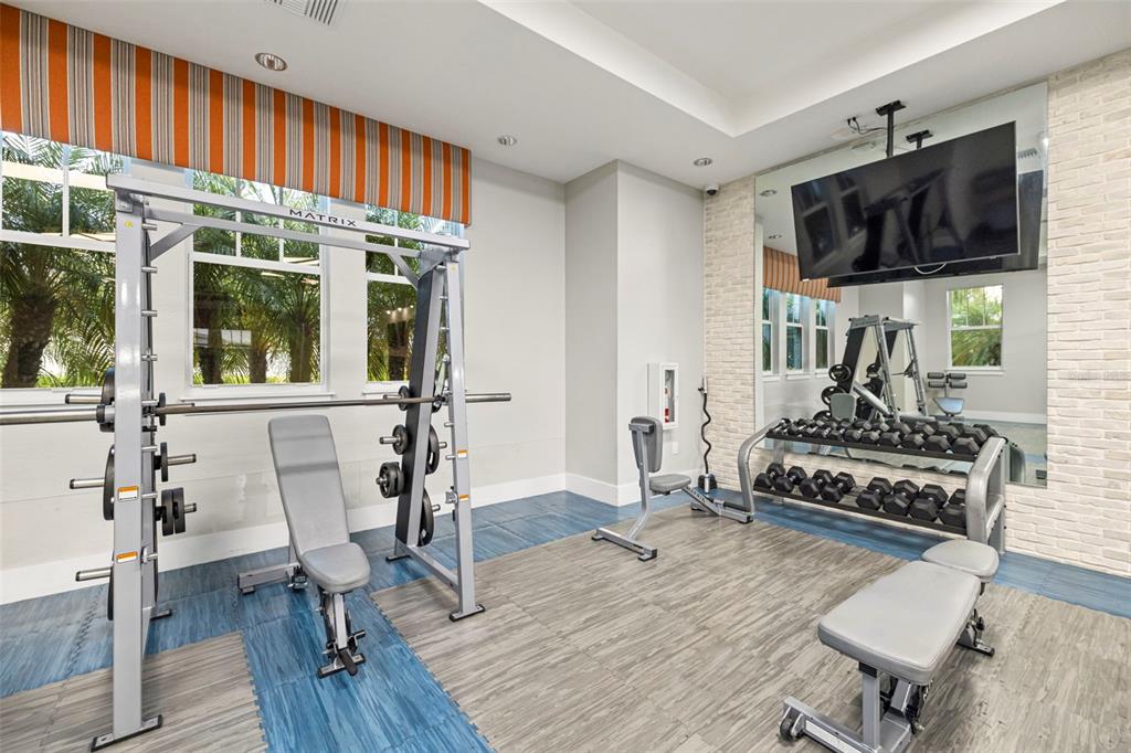 14375 Skipping Stone Loop Parrish, FL 34219 - Photo 76 of 87 a living room with furniture flat screen tv and chairs