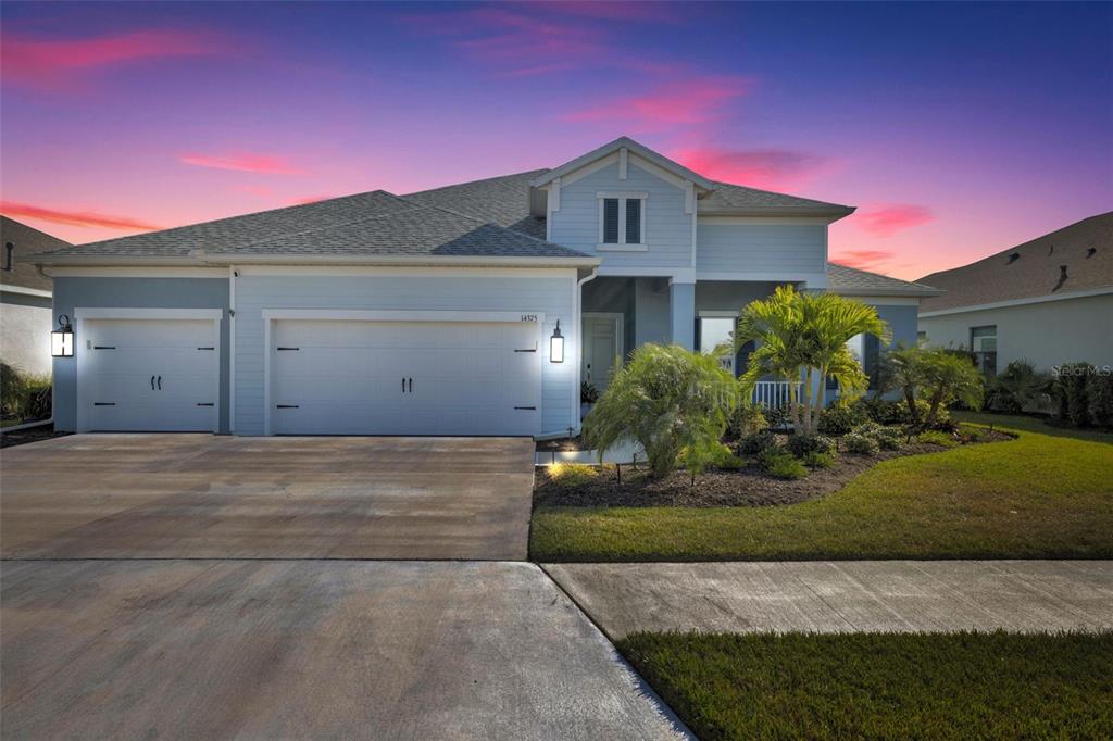 14375 Skipping Stone Loop Parrish, FL 34219 - Photo 84 of 87 a front view of a house with a yard and garage