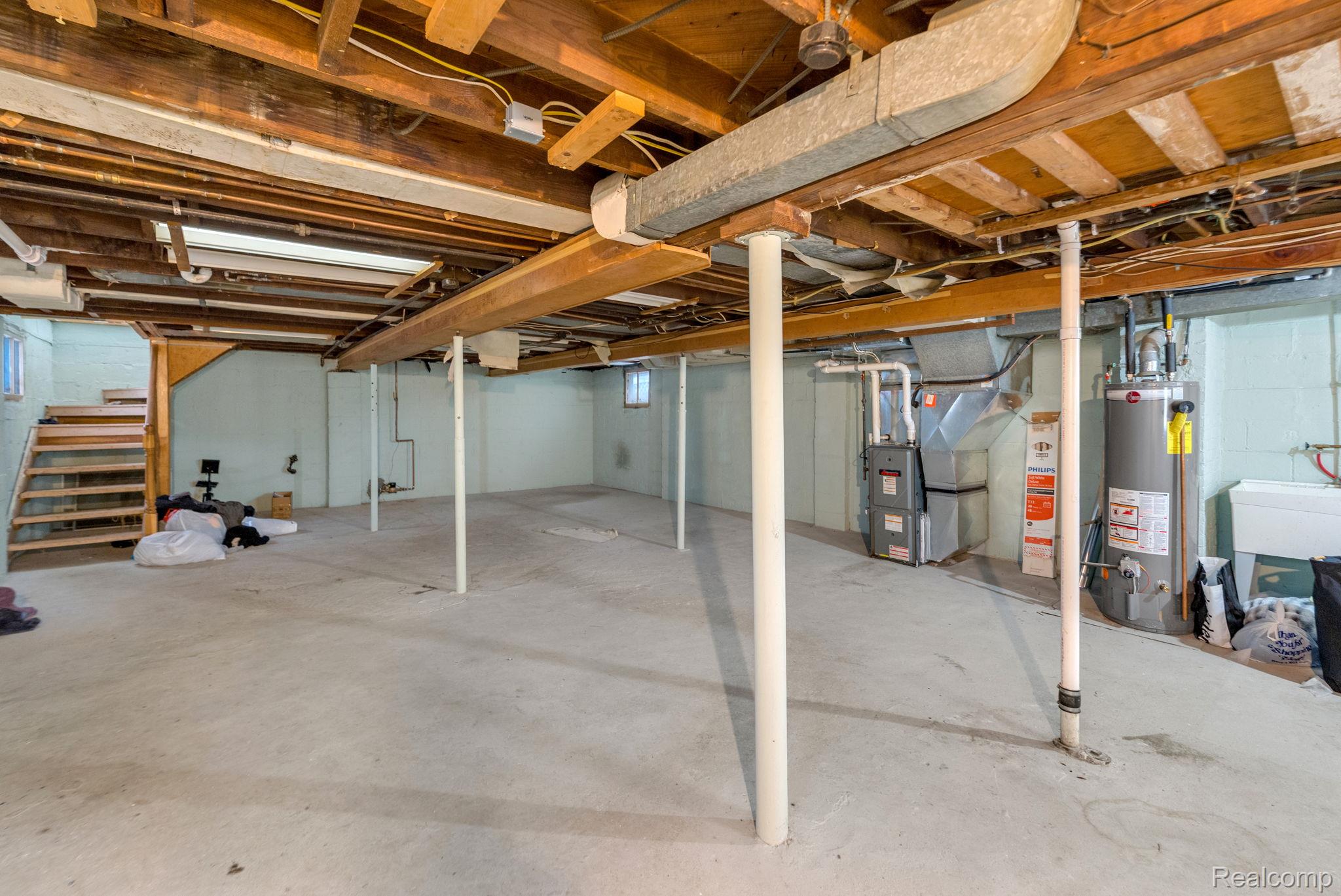 7631 Maple Street Dearborn, MI 48126 - Photo 48 of 48 Unfinished basement with concrete flooring and exposed ceiling beams