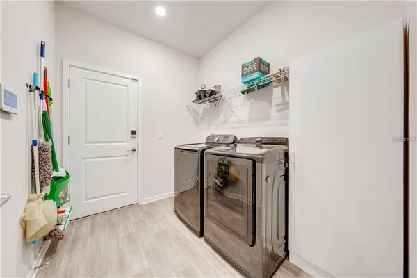 a large kitchen with stainless steel appliances granite countertop a lot of counter space and a sink