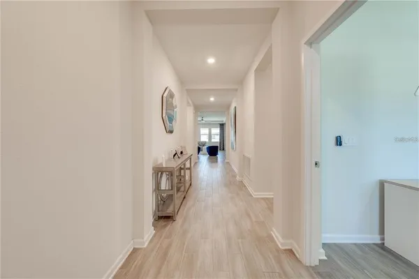 a view of a hallway with wooden floor