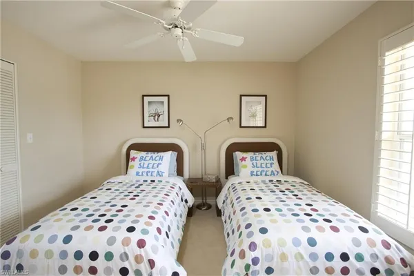 a bedroom with two beds and a lamp