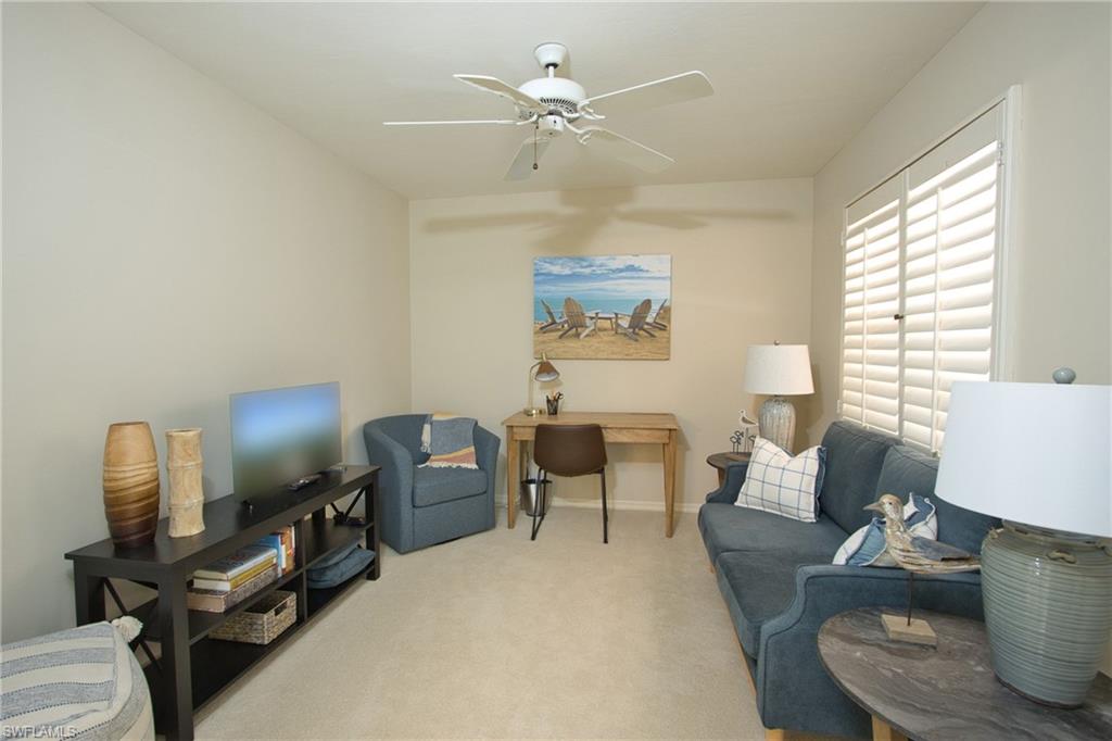 5637 Turtle Bay Drive, Unit II22 Naples, FL 34108 - Photo 14 of 20 a living room with furniture and a window