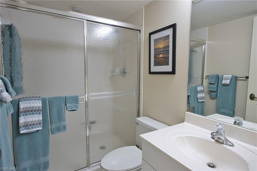 5637 Turtle Bay Drive, Unit II22 Naples, FL 34108 - Photo 15 of 20 a bathroom with a sink toilet and shower