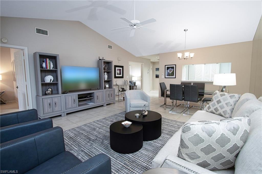 5637 Turtle Bay Drive, Unit II22 Naples, FL 34108 - Photo 4 of 20 a living room with furniture and a flat screen tv