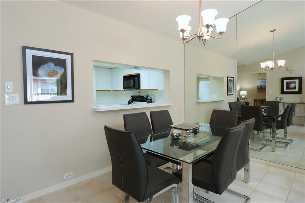 5637 Turtle Bay Drive, Unit II22 Naples, FL 34108 - Photo 5 of 20 a view of a dining room with furniture and a chandelier fan