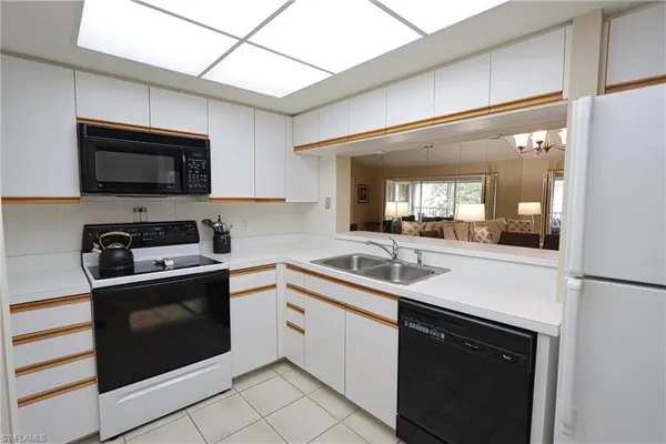 a kitchen with a sink stove and microwave
