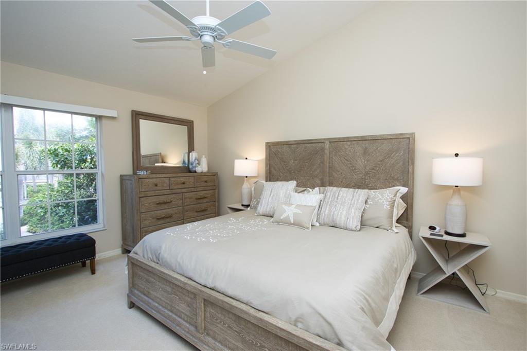 5637 Turtle Bay Drive, Unit II22 Naples, FL 34108 - Photo 7 of 20 a bedroom with a bed and a window
