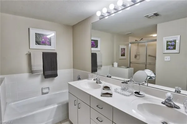 a bathroom with a tub sink and mirror