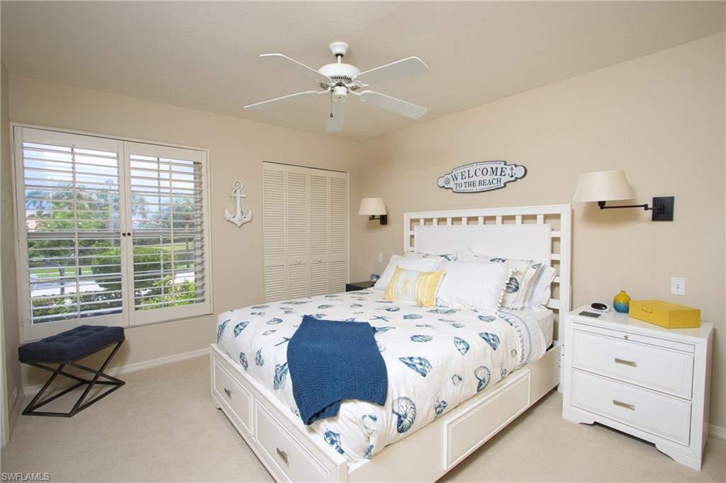 5637 Turtle Bay Drive, Unit II22 Naples, FL 34108 - Photo 10 of 20 a bedroom with a bed and a couch