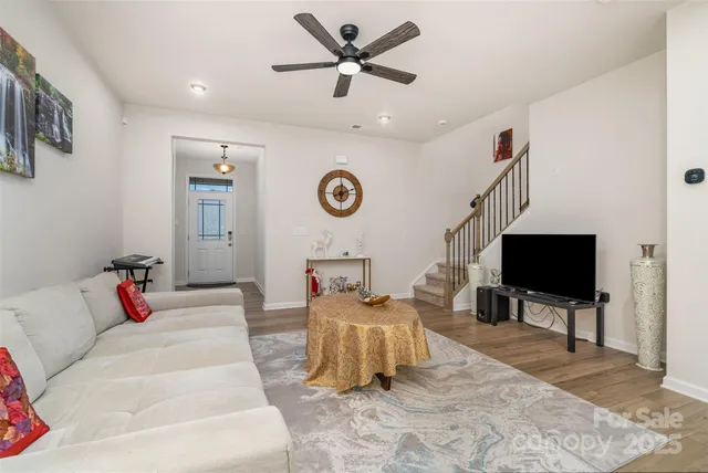 a living room with furniture ceiling fan and a rug