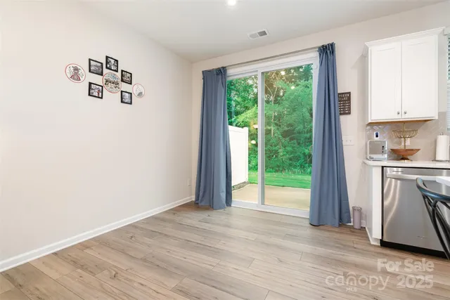 a view of kitchen with window and refrigerator
