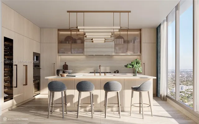 a kitchen with stainless steel appliances granite countertop a kitchen island a stove a table and chairs in it