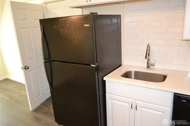 a close view of a sink and cabinets