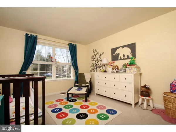 a bedroom with a bed and a dresser in it