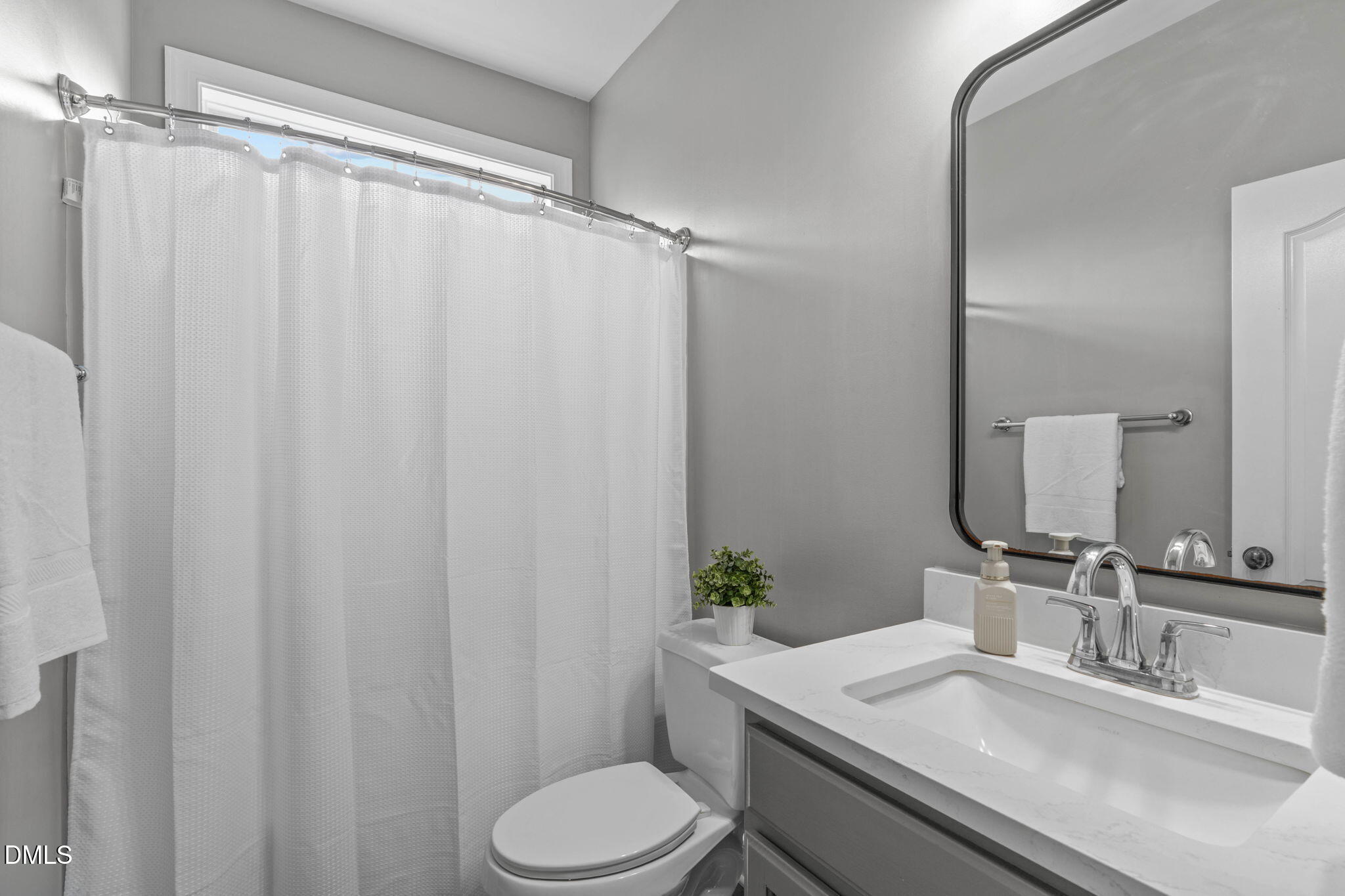 2450 Rolling Tracks Road Willow Spring, NC 27592 - Photo 36 of 64 a bathroom with a granite countertop sink toilet and a mirror