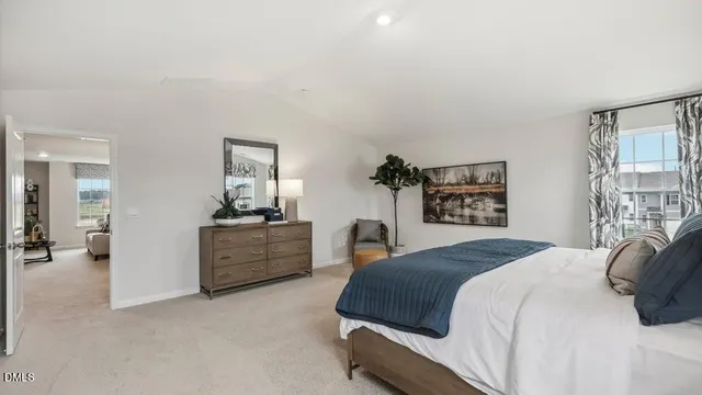a spacious bedroom with a bed and a couch