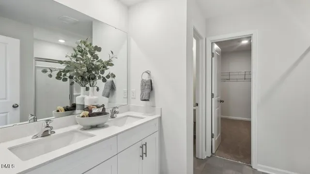 a bathroom with a double vanity sink and mirror
