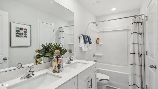 a bathroom with a granite countertop sink a toilet and shower