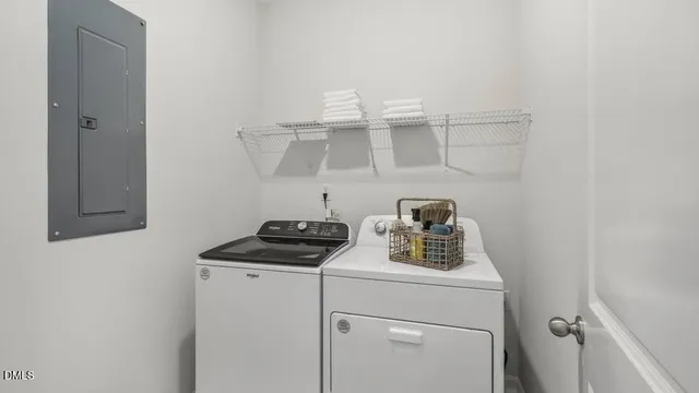 a view of storage and utility room with washer and dryer