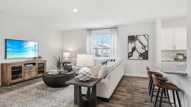 a living room with furniture fireplace and flat screen tv