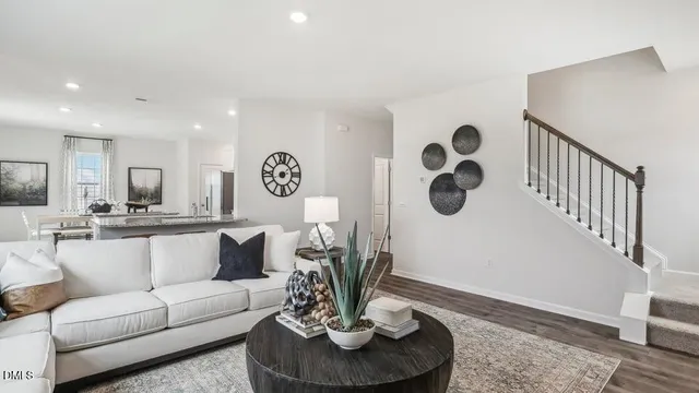 a living room with furniture potted plant and a window