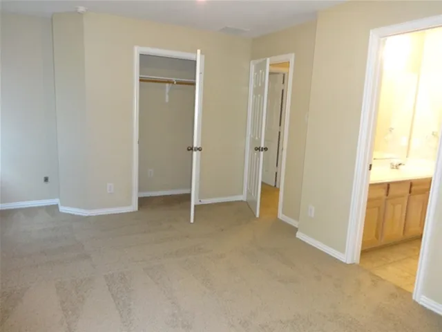 an empty room with closet and a window
