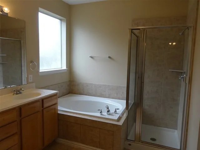 a bathroom with a tub and a sink