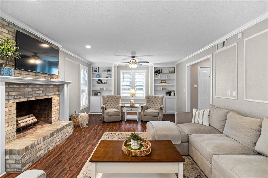 410 Simmons Road Double Oak, TX 75077 - Photo 9 of 40 Open-concept living area with fireplace focal point; perfect for relaxing or entertaining.