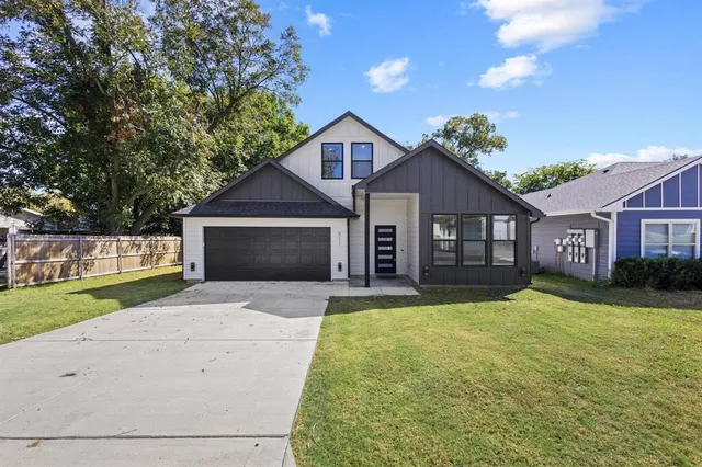 a front view of a house with yard and green space