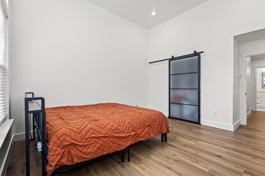 511 Maple Street Howe, TX 75459 - Photo 17 of 38 a bedroom with a bed and wooden floor