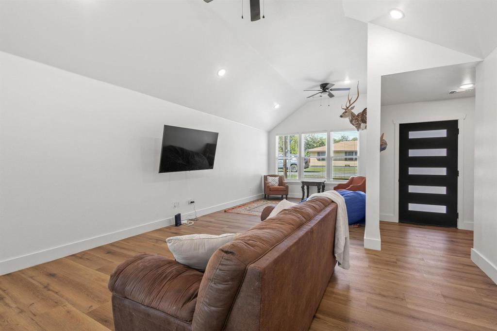 511 Maple Street Howe, TX 75459 - Photo 4 of 38 a living room with furniture a flat screen tv and a floor to ceiling window