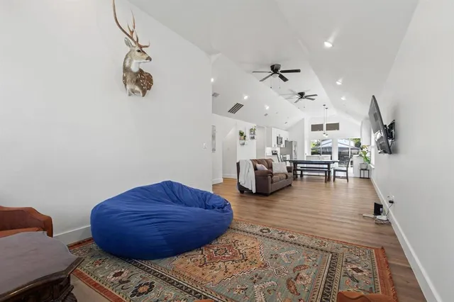 a living room with furniture and wooden floor