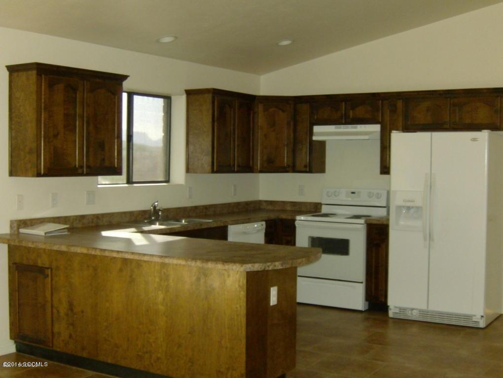 365 Via Papagayo Rio Rico, AZ 85648 - Photo 3 of 8 a kitchen with a sink and cabinets