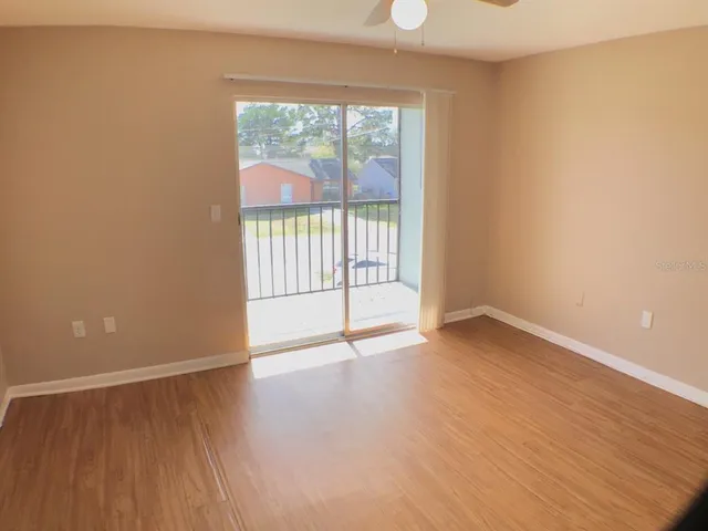 wooden floor in an empty room with a window