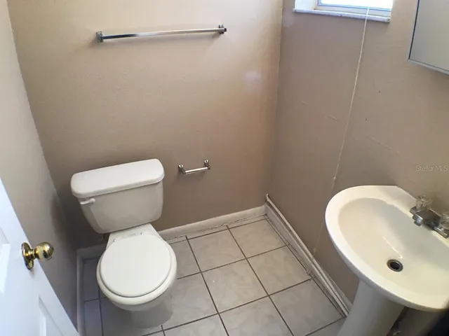a bathroom with a sink toilet and a mirror