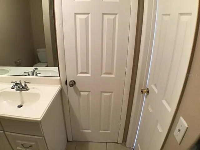 a bathroom with shower sink and mirror