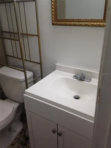 a bathroom with a sink and toilet
