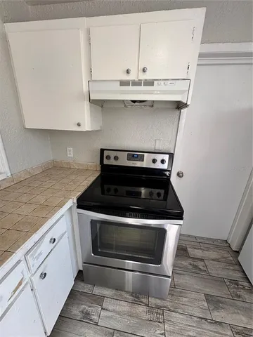 a stove top oven sitting inside of a kitchen