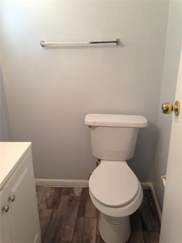 a white toilet sitting next to a shower