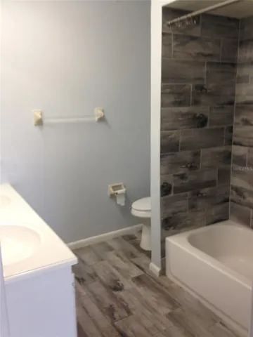 a bathroom with a bathtub and toilet